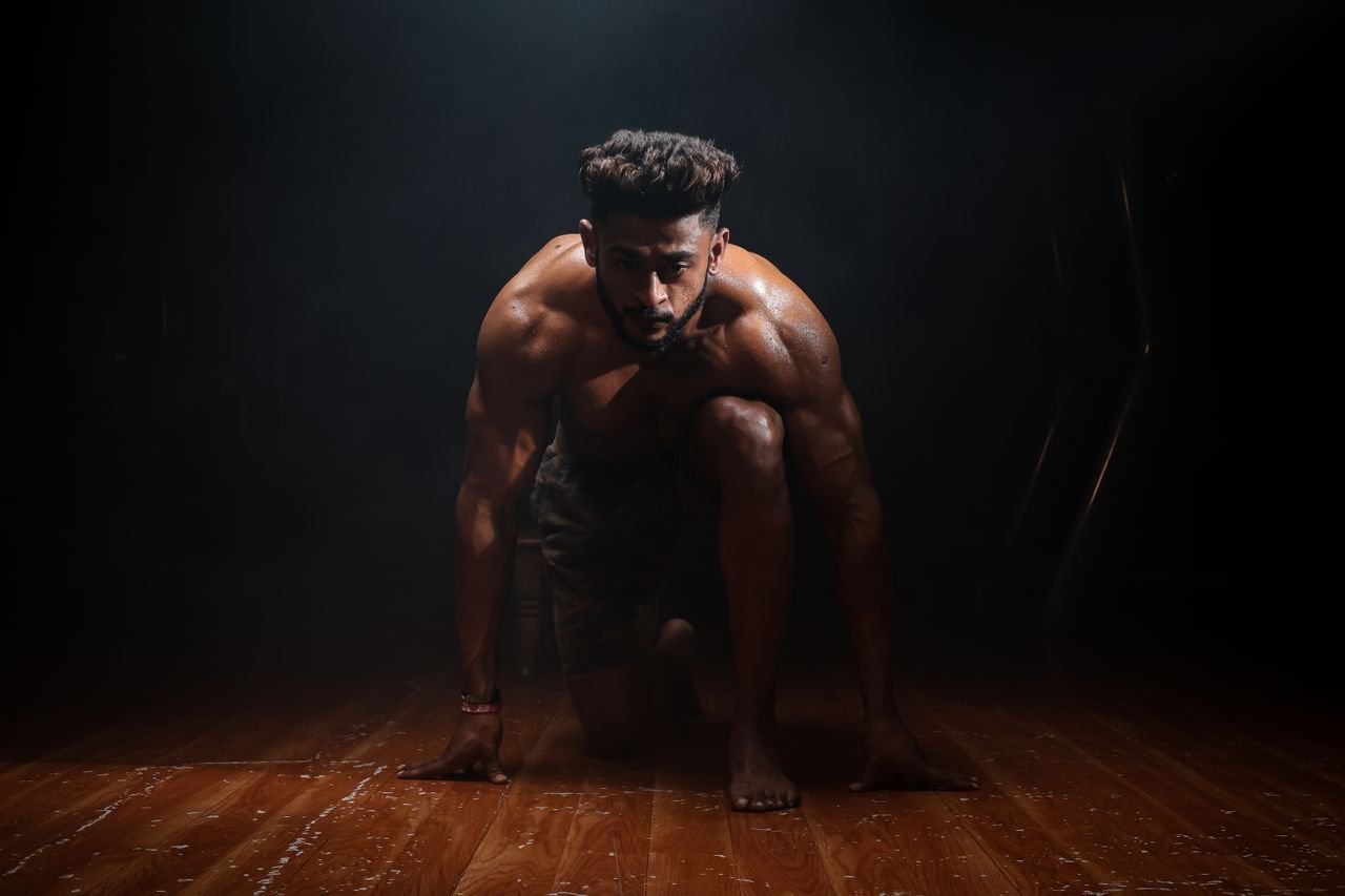 Crafting Captivating Headlines: Your awesome post title goes here Dynamic image of a muscular man in a kneeling start position, highlighting strength and focus.